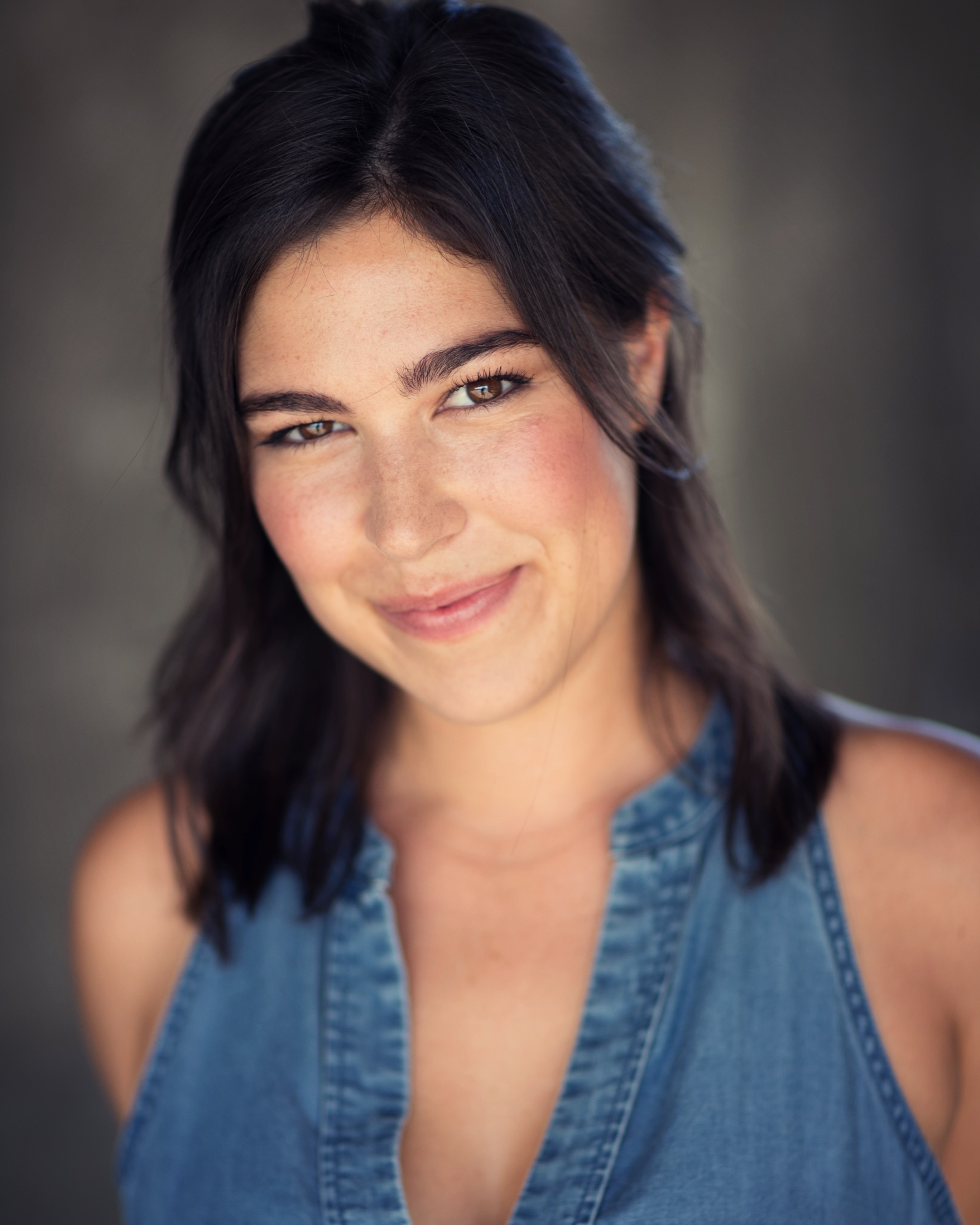 Suzanna smiling in a denim shirt